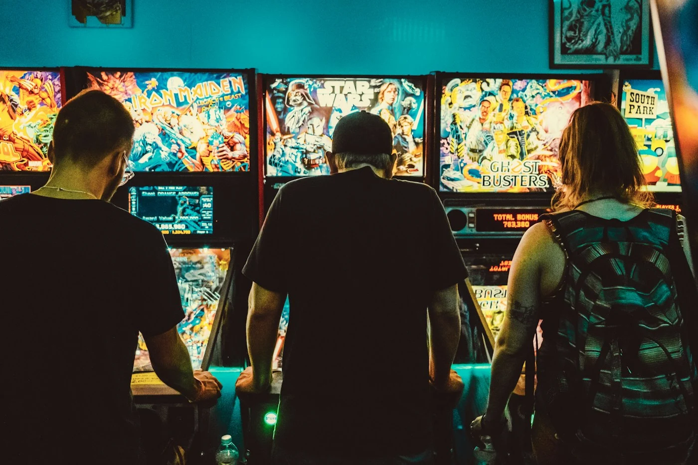 Players enjoying colourful pinball and arcade machines