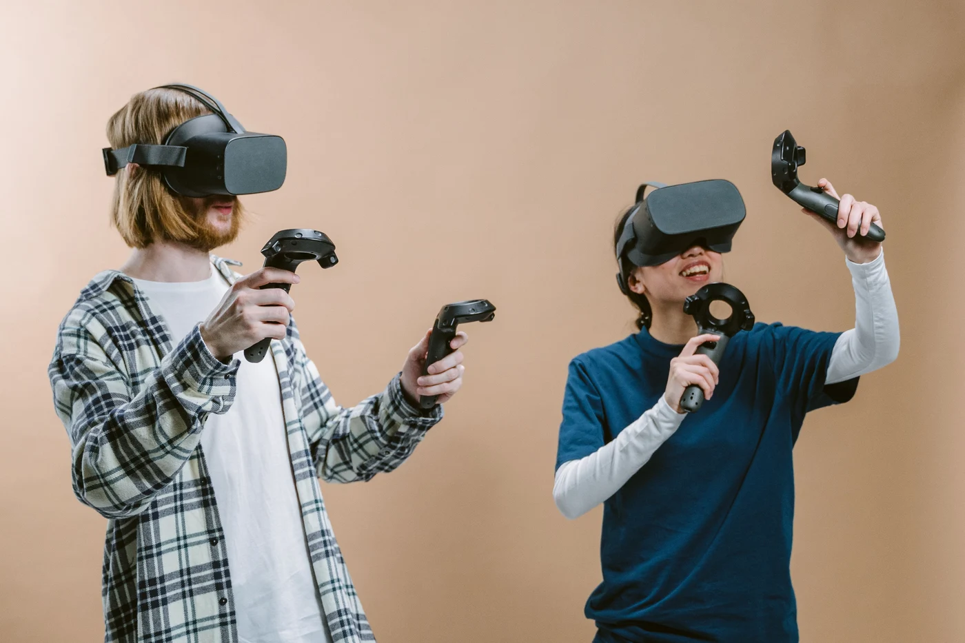 Two players exploring a game with virtual reality headsets and controllers